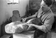 Henry Moore working on <i>Family</i> in the Top Studio, Perry Green, c.1943.<br><br>