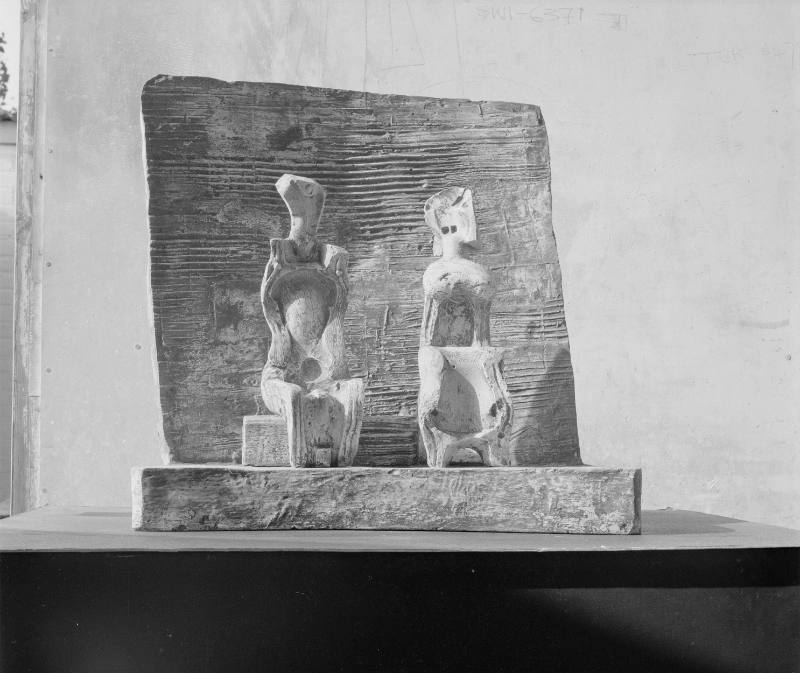 Two Seated Figures against Wall